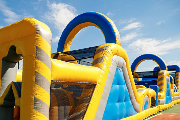 Inflatable obstacle course slide for kid games or team building outdoor activities Inflatable obstacle course slide for kid games or team building outdoor activities. obstacle course stock pictures, royalty-free photos & images