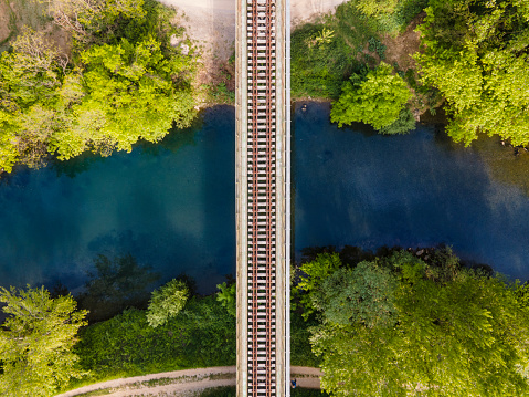 Directly Above Railroad Tracks Crossing a Beautiful River.