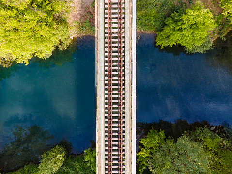 Directly Above Railroad Tracks Crossing a Beautiful River.