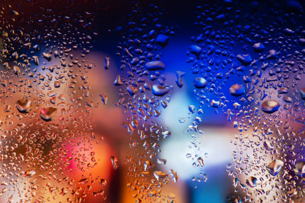 istock Condensation on the clear glass window. Water drops. Rain. Abstract background texture 1394807213