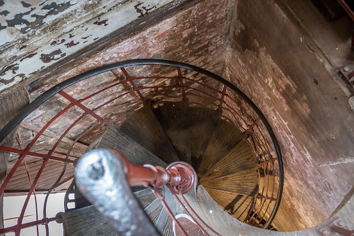 Looking down a cast iron spiral staircase