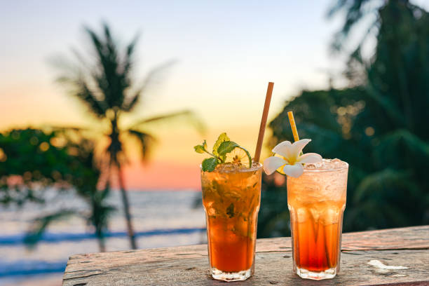 istock drinks with blur beach and sunset in background 1394807983