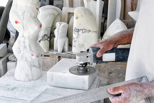 istock Crop craftsman polishing marble in workshop 1394809030
