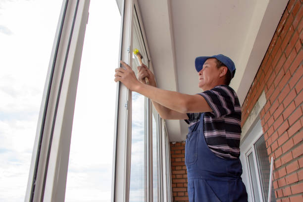 istock craftsmen workers install window in house rattle with a special rubber hammer 1394811346