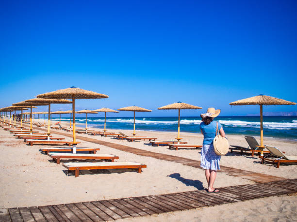 istock Woman walking at seaside in Greece 1394812434