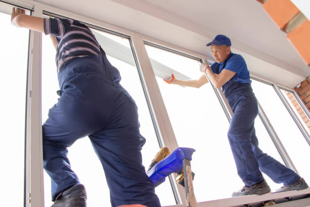 istock master workers install window sill repair in house building Asians 1394812794