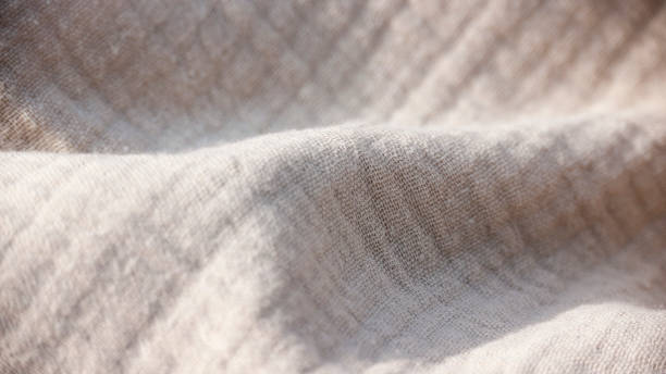 istock Beige muslin textile detail 1394813738