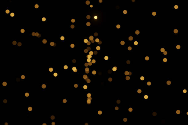 istock Defocused bokeh lights on black background, an abstract naturally blurred backdrop 1394813983