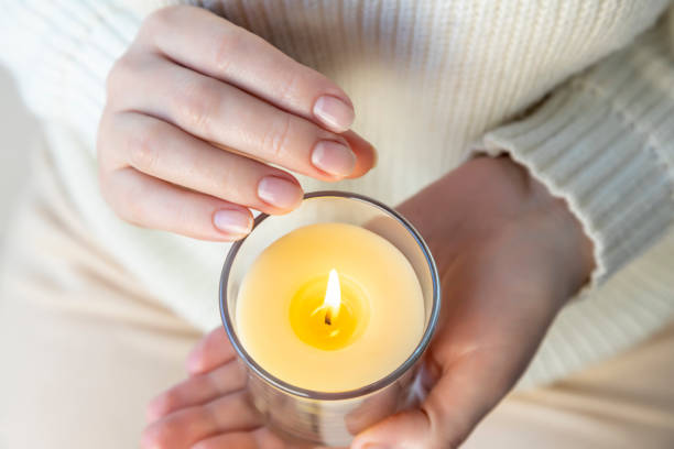 istock Heat from a candle on a woman's palm 1394815516