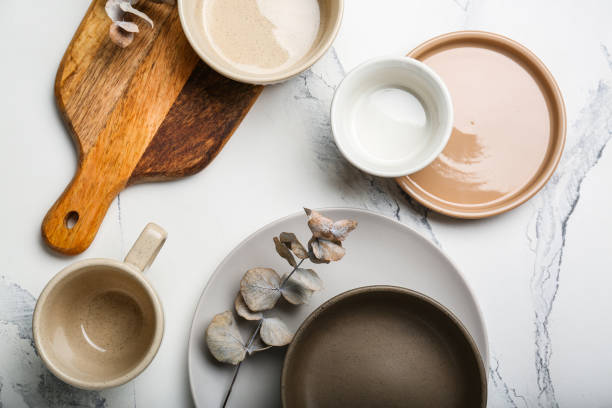 istock empty plates with cutlery cutting board and with cup on white background with eucalyptus branch 1394816694