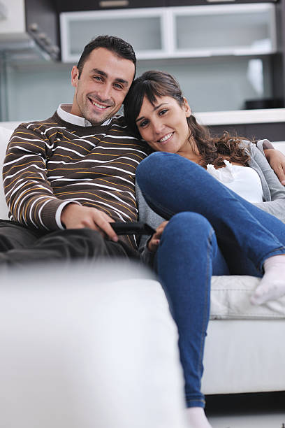 istock Relaxed young  couple watching tv at home 139481884