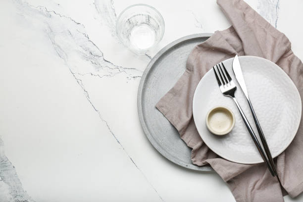 istock empty plate of different sizes with cutlery and glass on white background with space for text 1394819214