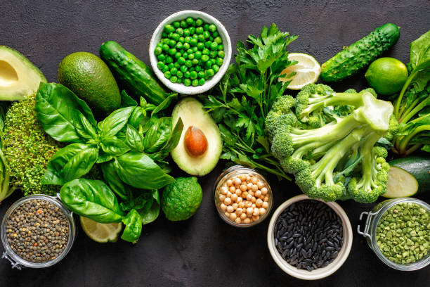 Healthy food clean eating: vegetable, seeds, superfood, leaf vegetable on dark background top view. Source of protein for vegetarians stock photo