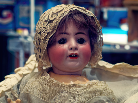 Evil antique doll at the flea market