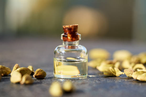 istock Essential oil bottle with cardamom seeds 1394823810