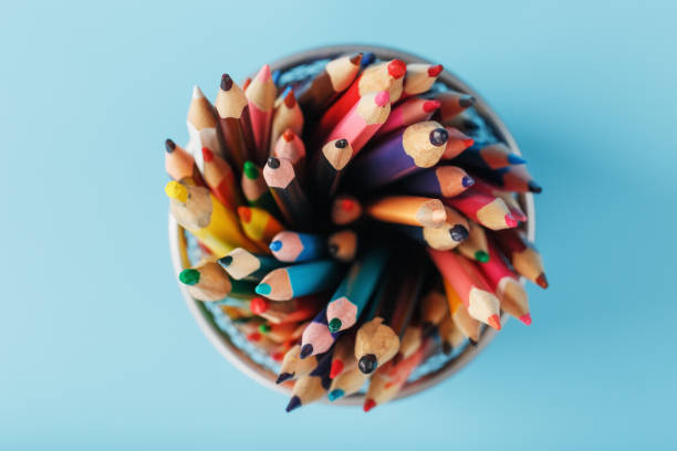 istock Colorful pencils in a metal jar on a blue background. 1394828166