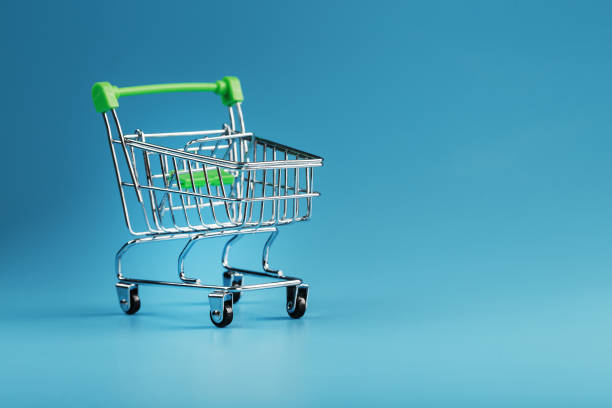 istock An empty supermarket cart on a blue background. 1394828211