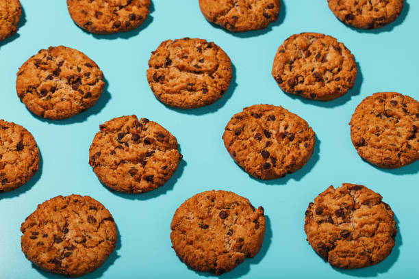 istock Oatmeal cookies with chocolate chip pattern and patterns on a light blue background. Full screen, top view 1394828958
