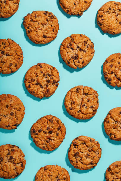 istock Oatmeal cookies with chocolate chip pattern and patterns on a light blue background. Full screen, top view 1394828978