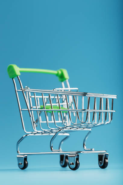 istock An empty supermarket cart on a blue background. 1394829393