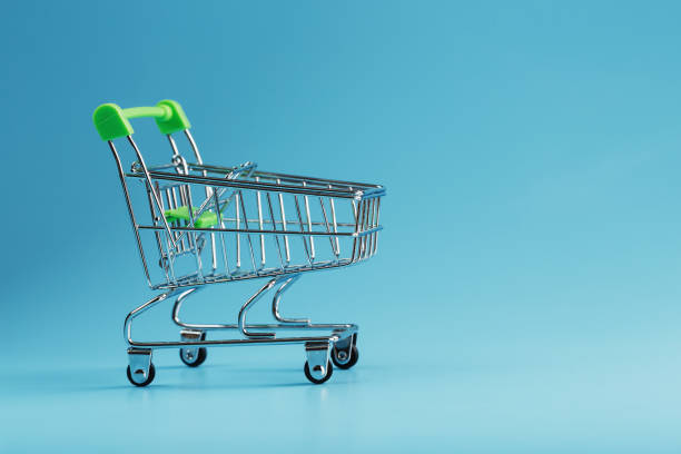 istock An empty supermarket cart on a blue background. 1394829486