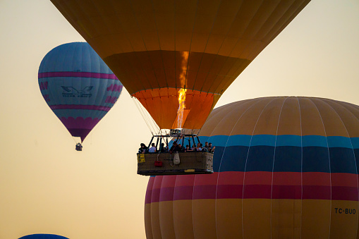 Hot Air Baloon Flying with Beautiful Colorful Dramatic Sky at Sunset