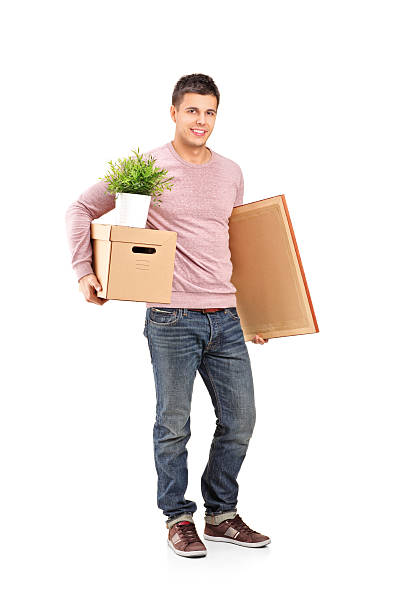 istock Smiling male moving into a new home 139483142
