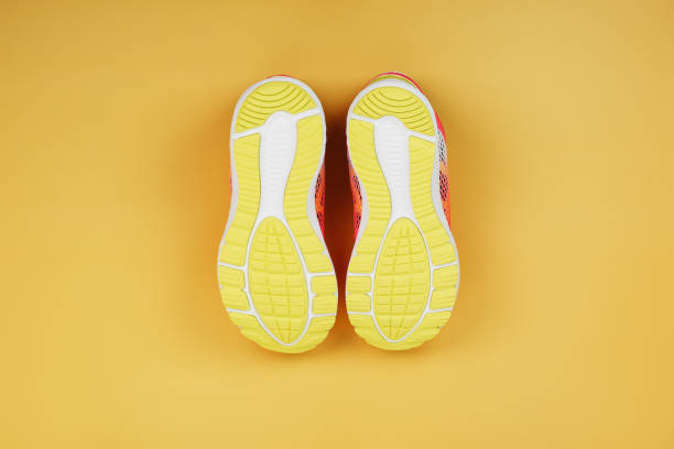 istock Yellow sole of a sneaker on a yellow background. 1394831847