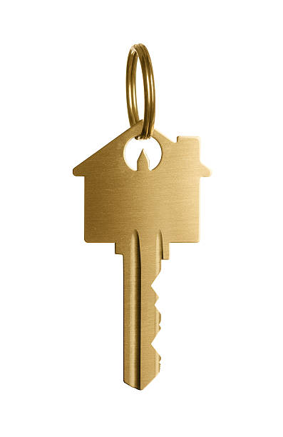 Golden key to a dream house Gold house shaped key isolated on white background computer key photos stock pictures, royalty-free photos & images
