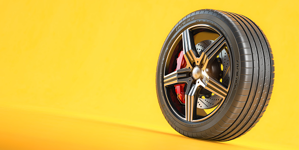 Car wheel. Disk with tyre and brakes on yellow background. 3d illustration