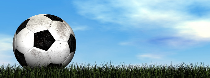 Dirty soccer ball on the grass - 3D render
