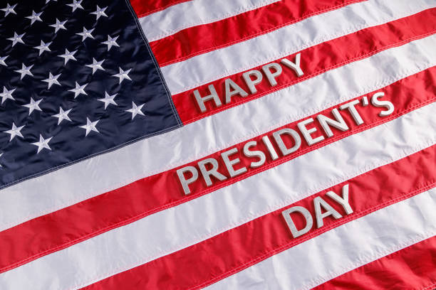 istock words happy presitdents day laid with real letters on US flag surface 1394836377
