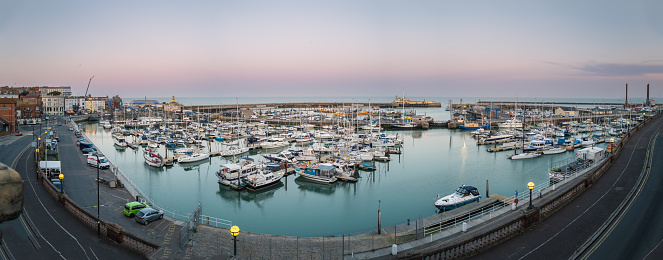 Gibraltar: flag of Gibraltar and the Government Ensign - seen against the Bay of Algerciras with the port, reclamation areas and the town on the lower right - photo by M.Torres