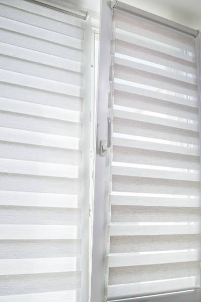 istock Window roller duo system day and night. Close up on roll curtains indoor. 1394841235