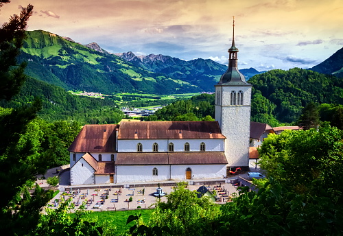 Saint-Theodule church and Alps mountains in the background, Gruyeres, Switzerland