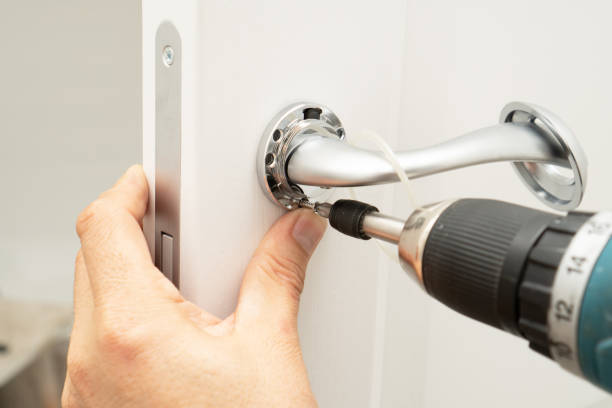 istock Service man installing magnetic lock and door handle on interior door using screwdriver. 1394844089