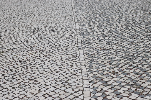 Pavement in Portugal. The small white limestone squares, sometimes mixed with black stones are typical throughout Portugal.