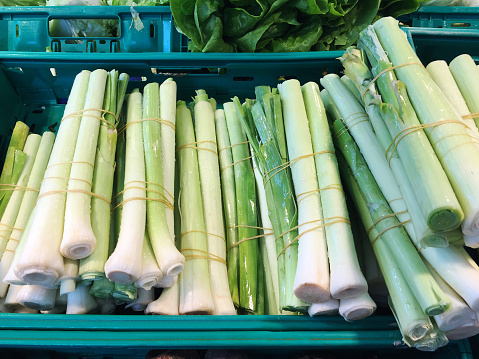 Leek vegetable, fresh vegetable leeks on the market stall
