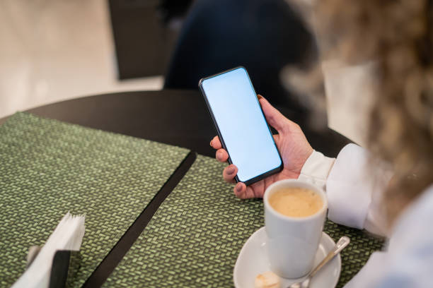 istock Female doctor using cell phone in cafe 1394855702