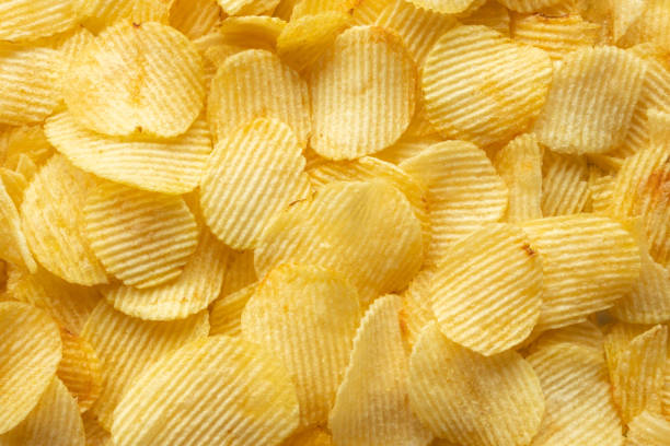 istock crispy golden potato chips snack texture background 1394858947