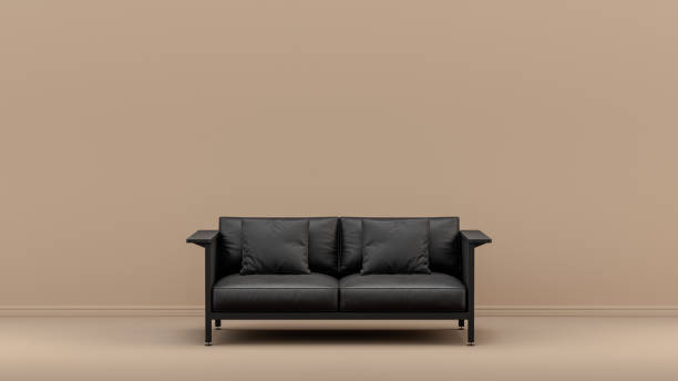 istock Single monochrome black couch in front of sienna brown empty wall Interior room 1394860320