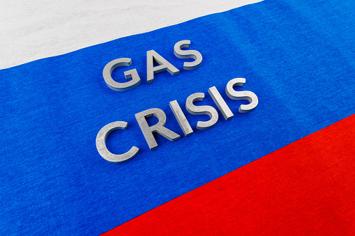 the words gas crisis laid with silver letters over flat full-frame russian flag surface in diagonal perspective view