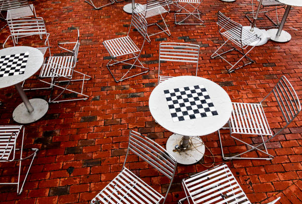 istock Chess tables and chairs on a Harvard Square brick patio - Cambridge Massachusetts 1394865237