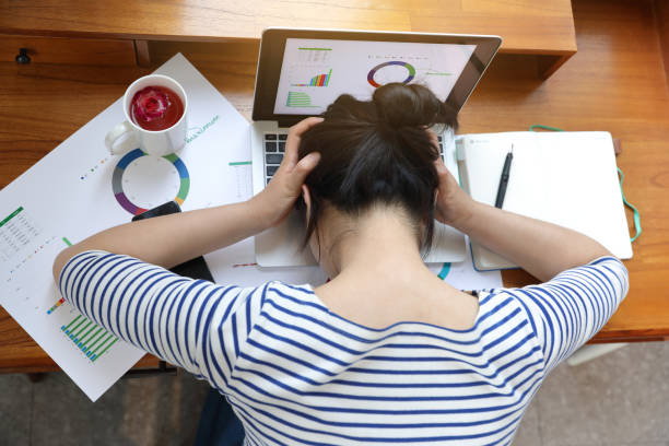 istock Frustrated woman on laptop at desk 1394865272
