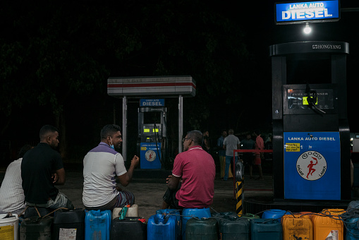 People wait during the night for a fuel delivery. Shot at 11pm. Sri Lanka Crisis. Sri Lankans experiences Fuel Shortages resulting in long lines at fuel stations. Food shortages and price increases that are not affordable for many people. Electricity power cuts routinely every day.