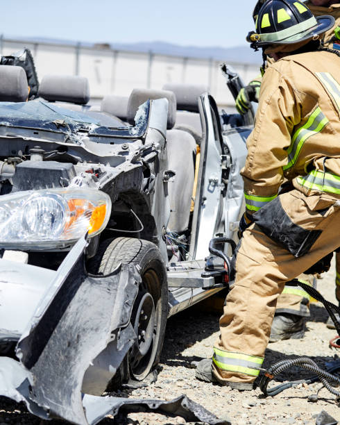 istock Fire Fighters using the Jaws of Life to dismantle a car 1394866038