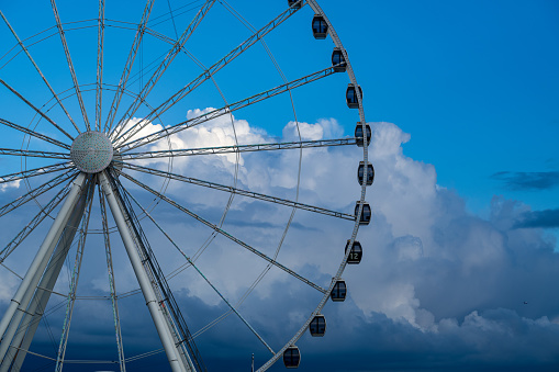 A dramatic Elliott Bay Cloudscape behind a Ferris Wheel.