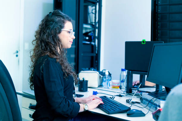 istock Woman in a TI office. Technical infrastructure. 1394867844