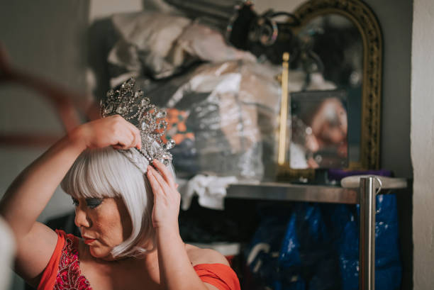 istock Asian Chinese drag queen wearing crown getting ready for performance at pub in dressing room 1394869171