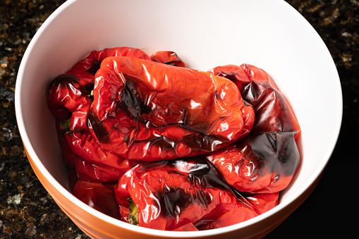 Home roasted red peppers in a bowl. Home cooking concept.